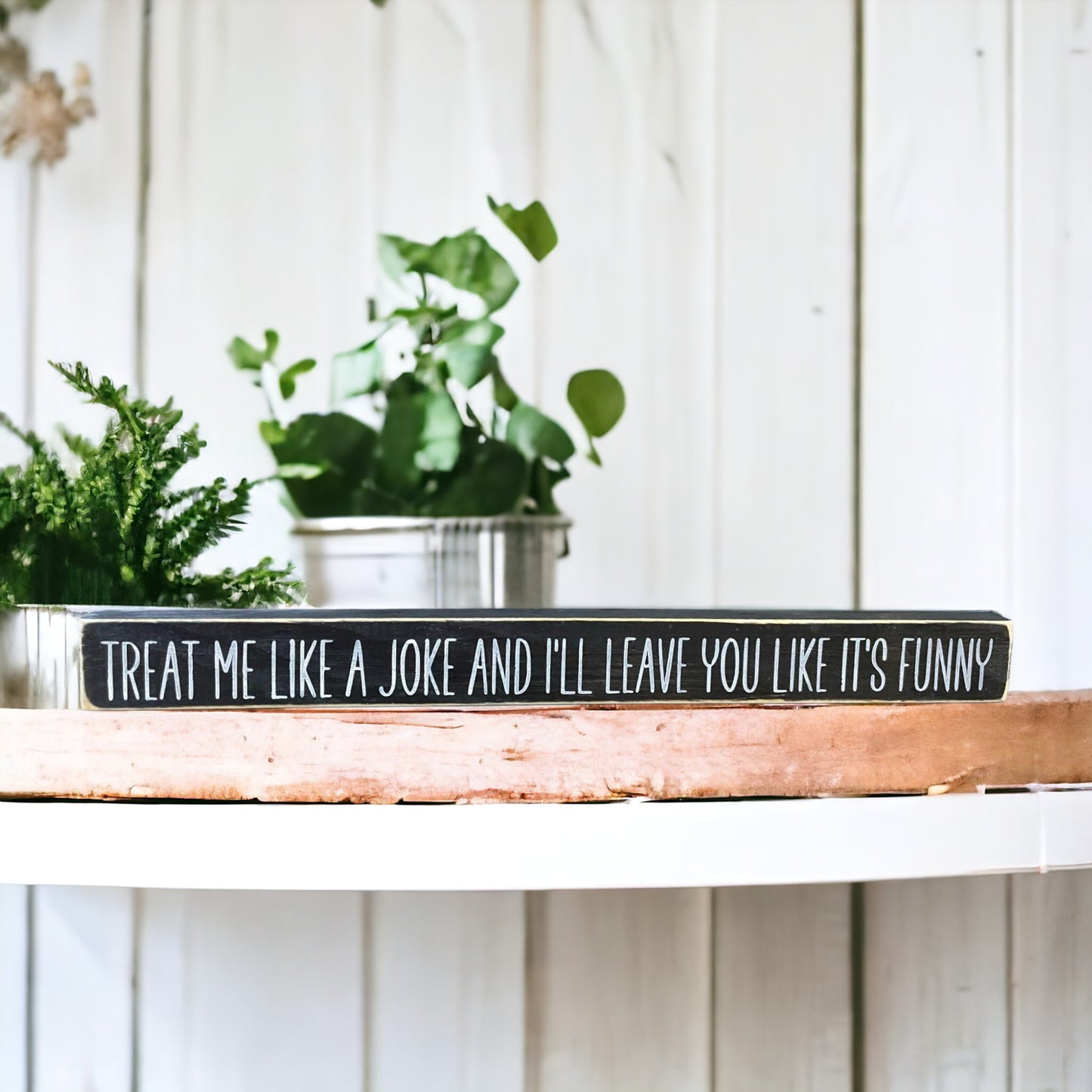 Handpainted black wood sign with white text reading 'Treat Me Like A Joke And I Will Leave You Like It's Funny,' freestanding 16-inch empowering decor for strong independent females.