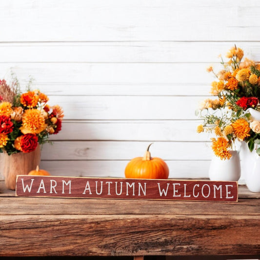 Hand-painted skinny wood sign in maroon with white text reading 'Warm Autumn Welcome' - ideal for fall mantel decor and autumn colors.