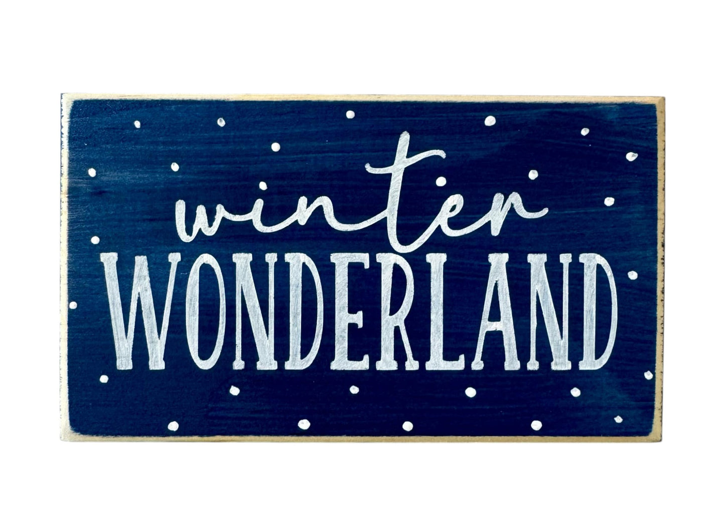 Handpainted wood block sign with “Winter Wonderland” in white text on a navy blue background, surrounded by delicate white snowflakes, ideal for winter mantel decor or home decorations.






