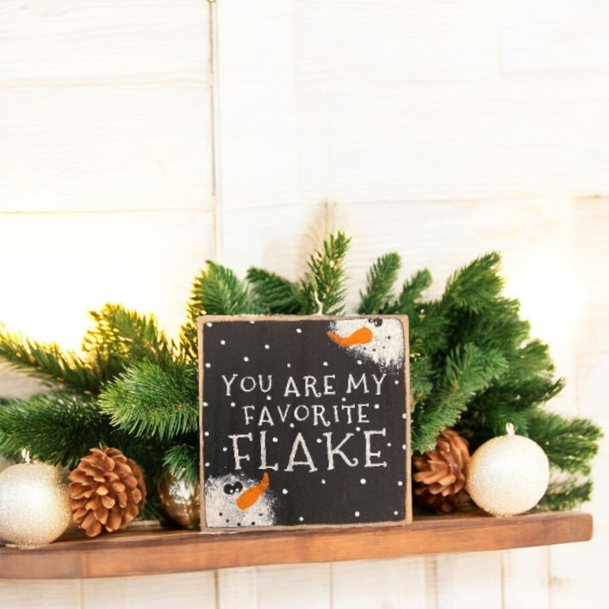 "You Are My Favorite Flake" wood block sign with a handpainted black background, white text, and snowman faces, perfect for primitive Christmas decor.