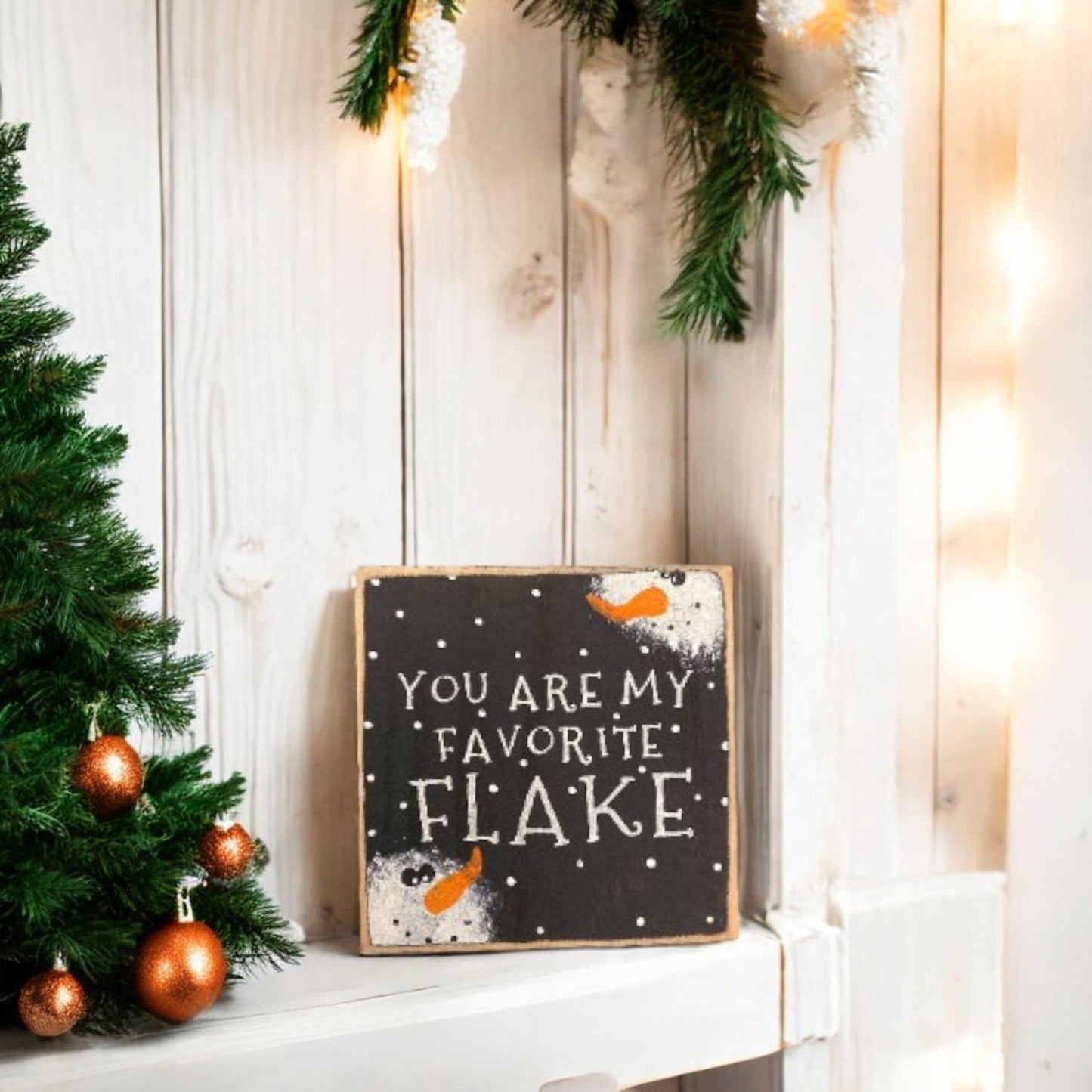 "You Are My Favorite Flake" wood block sign with a handpainted black background, white text, and snowman faces, perfect for primitive Christmas decor.