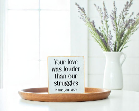 Handcrafted white wooden block sign with black text that reads, "Your Love Was Louder Than Our Struggles. Thank you Mom" – meaningful gift for mom.