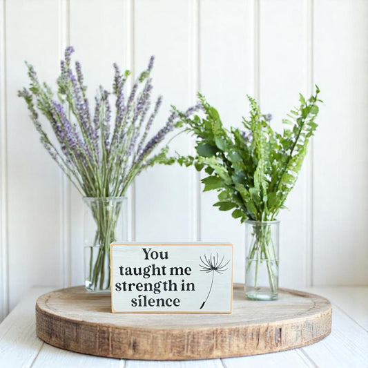 White handcrafted wooden block sign with black text that reads, "You taught me strength in silence" – appreciation gift for mom.